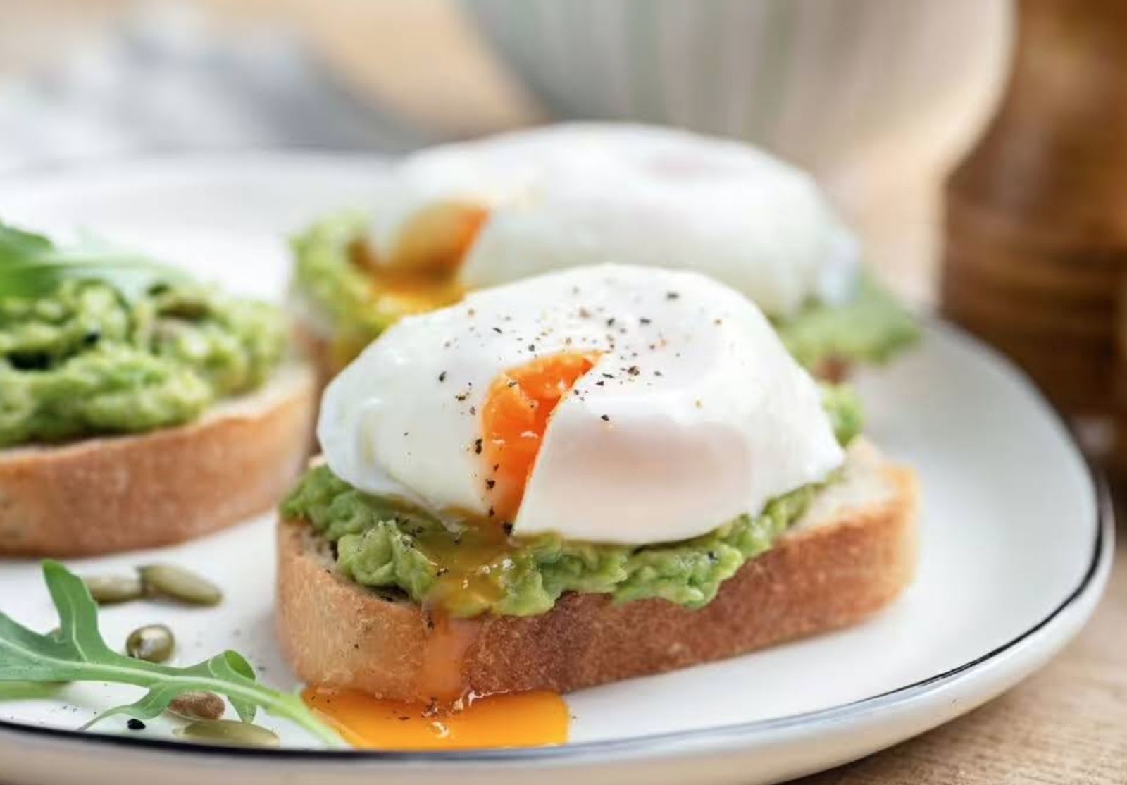 Poached eggs on smashed avocado sourdough at Siesta Café